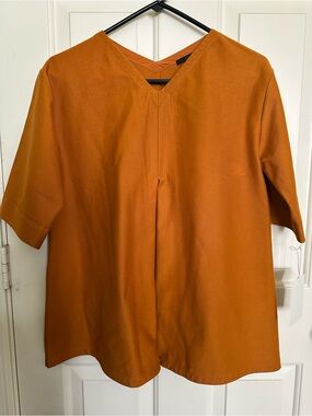 COS Women’s Short-Sleeve V-Neck loose pleated blouse in Mustard